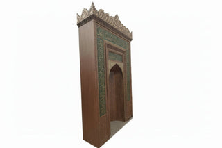 Decorative wooden archway with intricate carvings on a white background